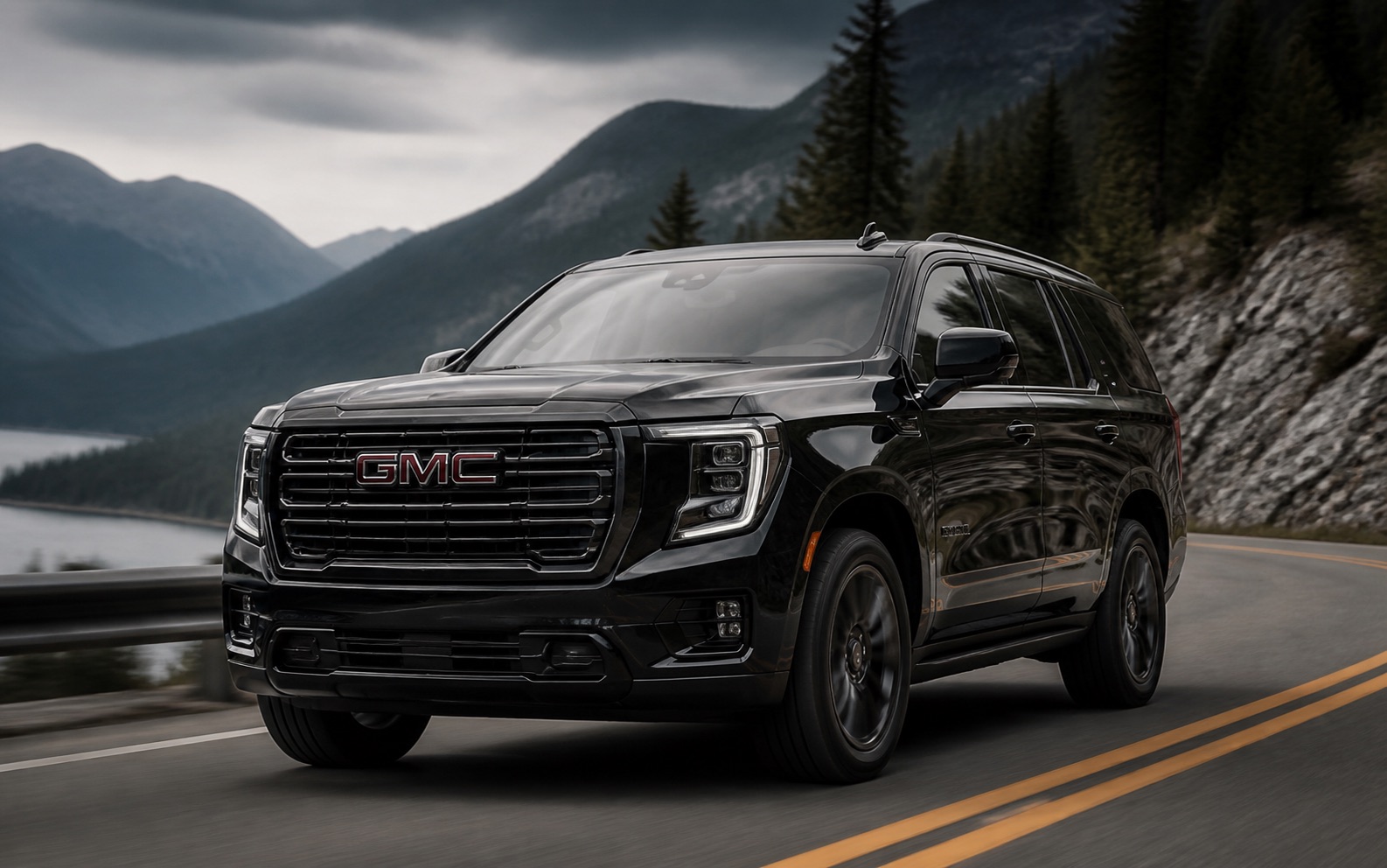 A black GMC SUV driving on a mountain road